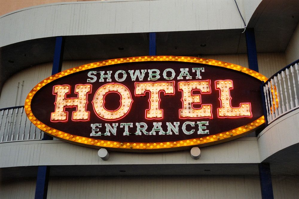 The illuminated SHOWBOAT HOTEL ENTRANCE sign, its letters outlined in incandescent bulbs on an ornate painted background