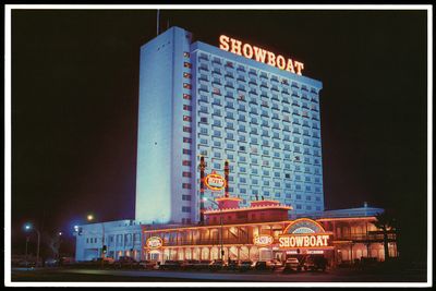 The Showboat hotel tower and neon-lined entrance glowing at night in the 1980s